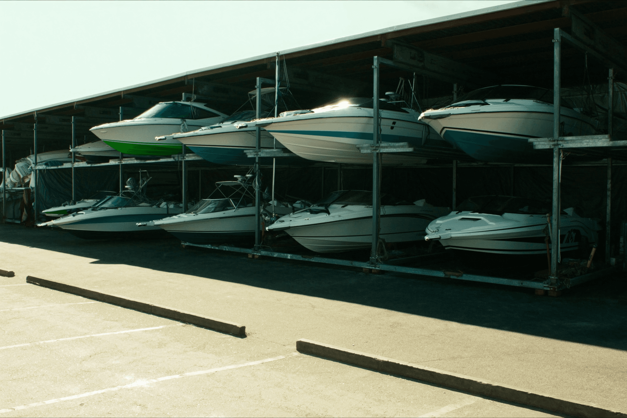 Boats stacked three high in the dry storage racks, forklift working the bottom row
